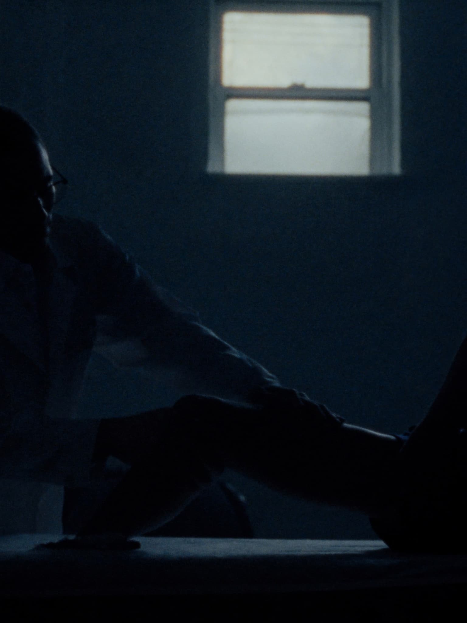 A physio works through a player's movement in the treatment room.